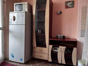 a kitchen with a white refrigerator and a microwave at Vintage Vibes - Family Flat in a Quiet Area in Sliven