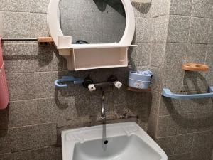 a bathroom with a sink and a mirror at Vintage Vibes - Family Flat in a Quiet Area in Sliven +17 photos