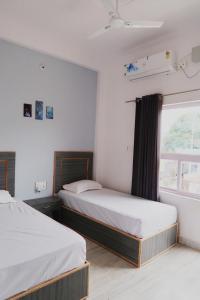 A bed or beds in a room at Aarambh Residency