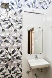 a bathroom with a sink and a mirror at Aarambh Residency in Khajurāho