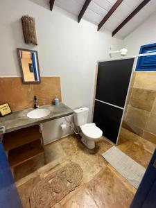 uma casa de banho com um WC, um lavatório e um chuveiro em Chales Barra Grande em Barra Grande