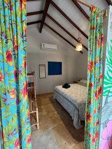 um quarto com uma cama e uma televisão num quarto em Chales Barra Grande em Barra Grande