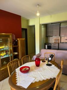 a table in a room with a kitchen and a dining room at HIPPOCAMPUS APARTMENT in Stratónion