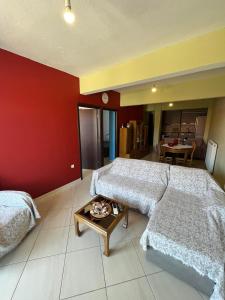a large bedroom with two beds and a table at HIPPOCAMPUS APARTMENT in Stratoni