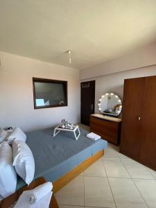 a hotel room with a bed and a tv on the wall at HIPPOCAMPUS APARTMENT in Stratónion