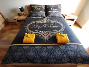 a blue bed with yellow pillows on it at Apartament Perełka in Jelenia Góra