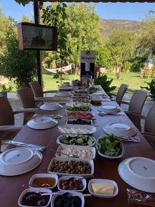 a long table with plates of food on it at Nirvana Boutique Hotel in Datca