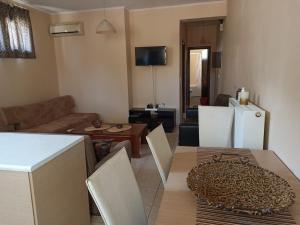 a kitchen and living room with a couch and a table at New Village apartment in Chios