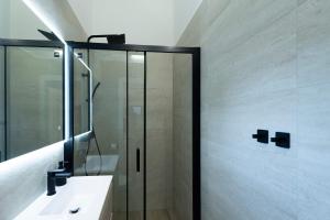a shower with a glass door in a bathroom at Lapidea apartments in Skradin +2 photos