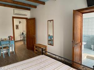 a bedroom with a bed and a bathroom at B&B Alba Chiara in Oristano