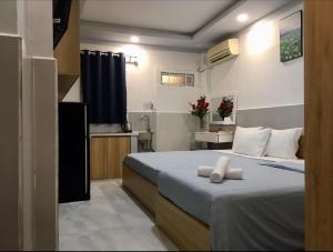 a hotel room with a bed and a bathroom at Saigon Cozy Home " At BuiVien Walking Street " - Self Check In in Ho Chi Minh City +33 photos