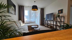 a living room with a couch and a table at 2 room Apartment, with terrace, new building, 210 in Bratislava