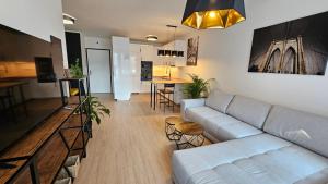 a living room with a couch and a kitchen at 2 room Apartment, with terrace, new building, 210 in Bratislava