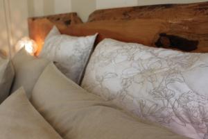 a group of pillows sitting on top of a bed at The Beeches Olinda Accommodation in Olinda