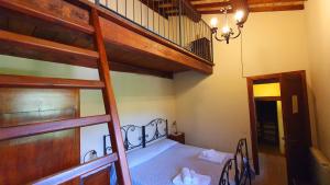 a bedroom with a bunk bed and a staircase at Agriturismo Santa Giusta in Poggio San Lorenzo
