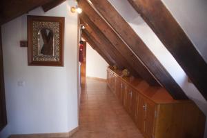 an attic hallway with a staircase and a mirror at Hostal Mar de Frente in Los Caños de Meca