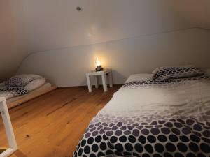 a bedroom with two beds and a table with a candle at Loft la plus belle vue du lac Léman Montreux in Montreux