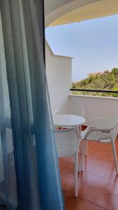 a balcony with a table and chairs and a window at Benalmarina Sea View Apartments in Benalmádena