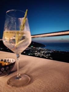 a wine glass sitting on a table with a view of the ocean at Thai Boutique rooms in Peschici