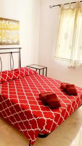 a red bed with pillows on it in a bedroom at Benalmarina Sea View Apartments in Benalmádena