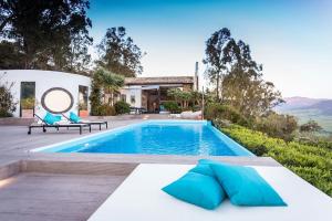 a villa with a swimming pool and a house at Villa Tarifa Lodge in Tarifa