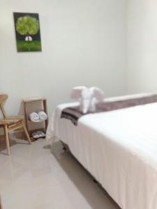 a bed in a room with a table and a chair at Narastay in Yogyakarta