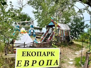 a sign that reads eclecticism ebopula next to a playground at Budget First Sea Line Apt. FLORA in Pomorie