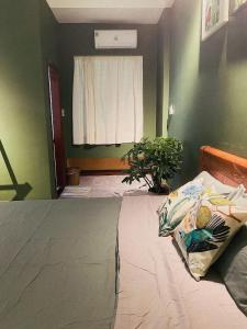 1 dormitorio con cama, ventana y planta en Coc.Coc Home en Hue