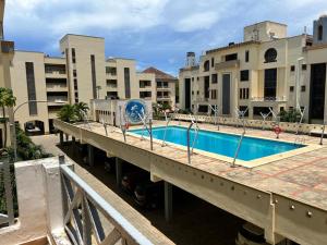 a bridge with a swimming pool in a building at Lux Suites Marrakech Apartments in Mombasa