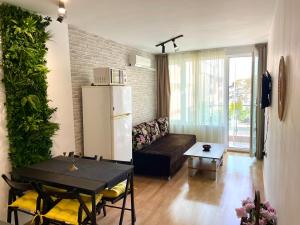 a living room with a couch and a table at First Sea Line Apartment FLORA, next to the beach in Pomorie