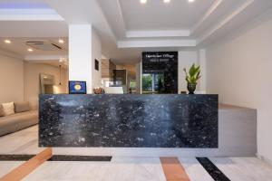 a lobby with a black marble counter in a room at Dimitrios Village Beach Resort in Rethymno