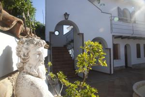 a statue in front of a building at Hostal Mar de Frente in Los Caños de Meca