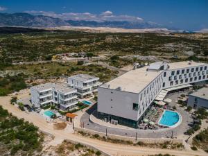 an aerial view of a building with a pool at VILLA CALA, Hotel Rooms&Apartments in Novalja