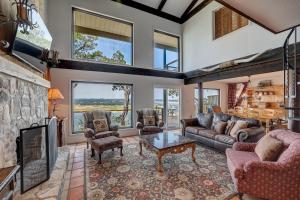 a living room with a couch and a table at Perched Above the River in Lago Vista