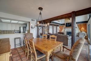 a kitchen and dining room with a wooden table and chairs at Perched Above the River in Lago Vista