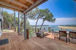 a deck with a table and chairs and the ocean at Perched Above the River in Lago Vista