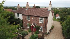an aerial view of a brick house with a red door at Holly Cottage in Gringley on the Hill