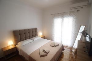 Posteľ alebo postele v izbe v ubytovaní Cozy home in Athens