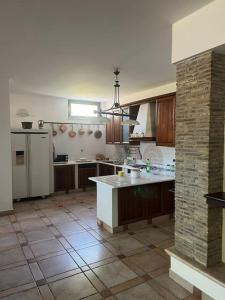 a kitchen with a island in the middle of it at Villa Emma in Torrevecchia Teatina