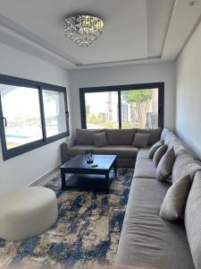 a living room with a couch and a coffee table at Villa Marina Hills - Tamuda Bay in Jebel Zemzem