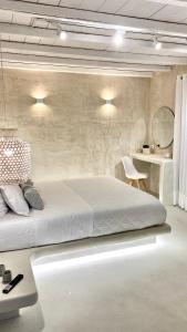 1 dormitorio con 1 cama blanca grande en una habitación en Moustakas Beach Apartments, en Adamas