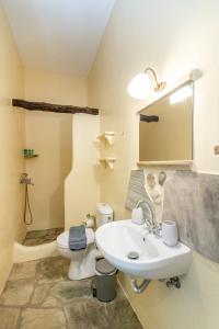a bathroom with a white sink and a toilet at ReGenesis Villas in Kardhianí +74 photos
