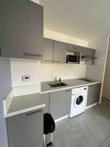 a kitchen with a sink and a washing machine at Beautiful flat with sunny balcony in heart of Nice Le Port in Nice