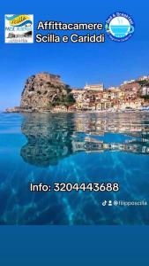 a view from the water of the ocean with a city in the background at Scilla e Cariddi in Scilla