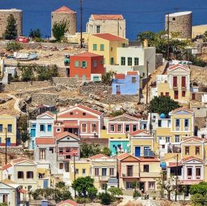 a group of houses on top of a hill at Little Blue in Chorio, Symi in Symi