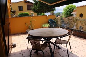 einen Tisch und Stühle auf einer Terrasse mit Balkon in der Unterkunft Chalet en Comillas in Comillas