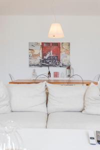 a living room with two white couches and a lamp at Villa Magnolia - High standing floor in Locarno