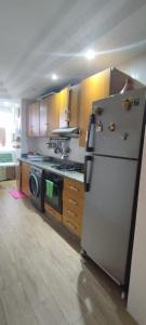 a kitchen with a refrigerator and a stove top oven at Chambre haut standing in Rabat