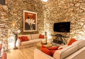 a living room with a stone wall at Villa Tarifa Lodge in Tarifa