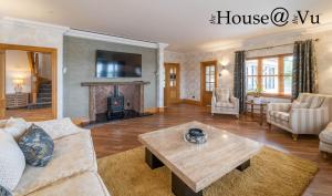 a living room with a couch and a table at The Hoose at The Vu in Bathgate